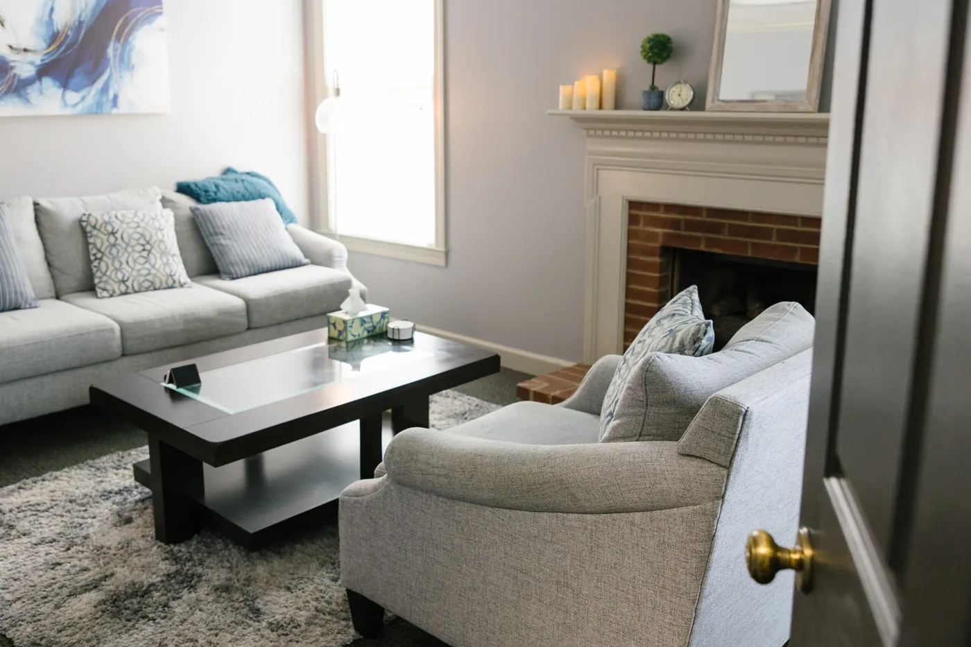 The sitting area of my Brentwood office, with a sofa, armchair and fireplace